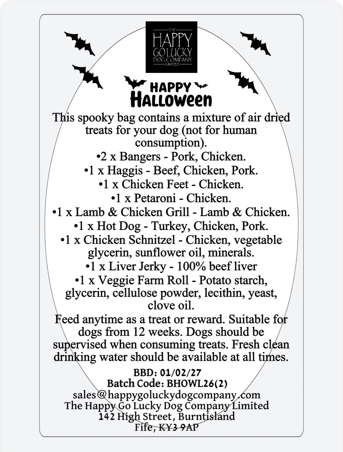 A white rectangular label with rounded corners containing Halloween-themed product information for a dog treat bag. The label has black bats flying across the top and a large 'Happy Halloween' heading, followed by a list of included treats such as Bangers, Haggis, Chicken Schnitzel, Lamb & Chicken Grill, Hot Dog, Liver Jerky, and Veggie Farm Roll.